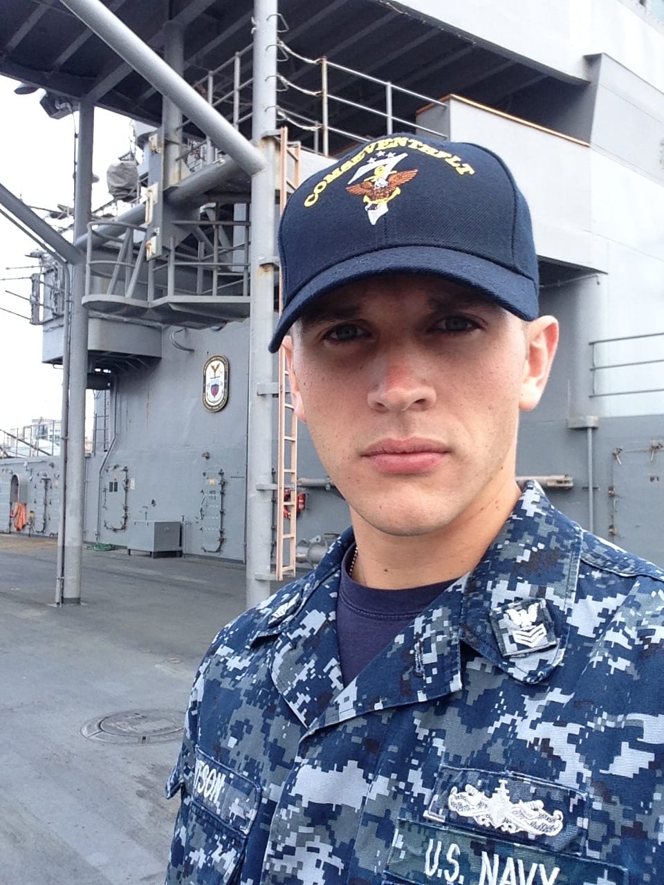 Cody in Navy uniform aboard a ship